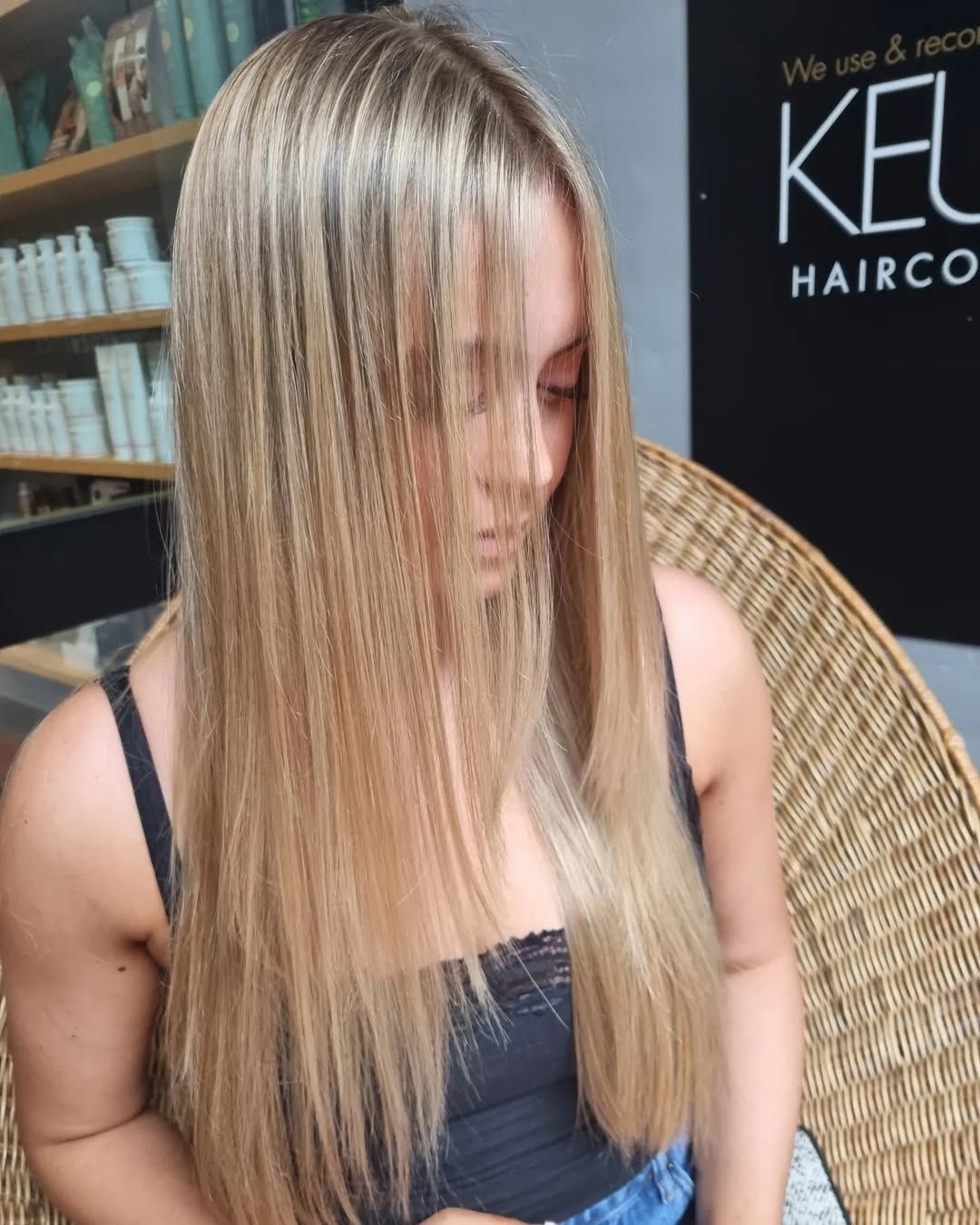 A Woman is Getting Her Hair Blow Dried by a Hairdresser in a Salon — Energy Hair Co in Noosa Heads, QLD