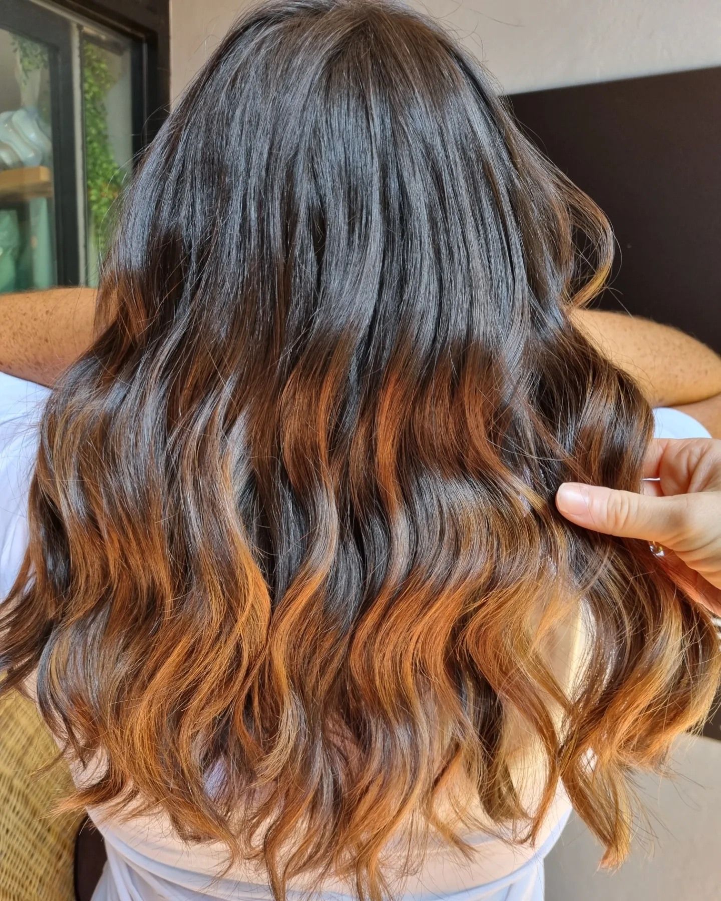 Woman's wavy hair with dark roots blending into ombre copper-brown tips — Energy Hair Co in Noosa Heads, QLD