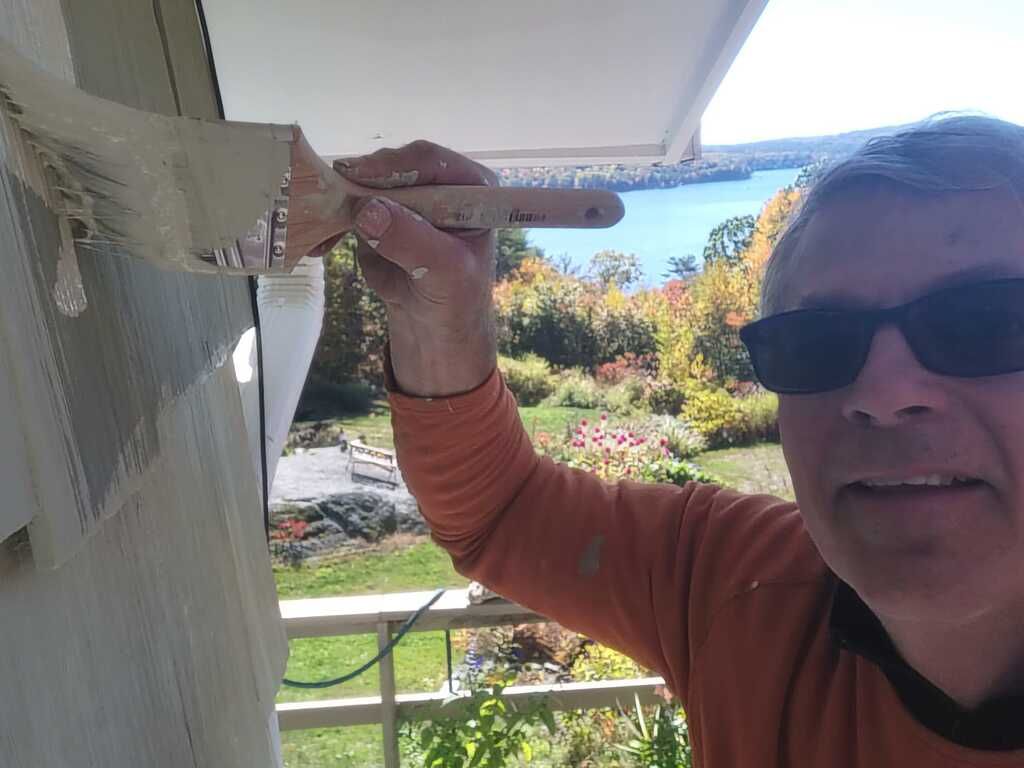 Dan is painting a wall with a brush