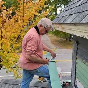 Dan is working on the roof of a house Dan is working on the roof of a house