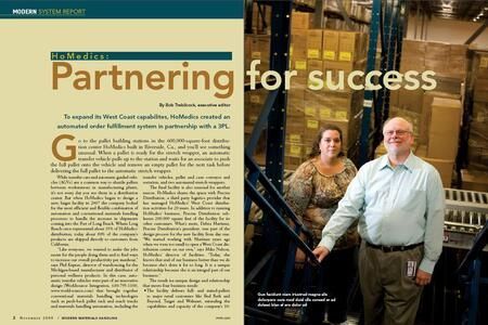 Two people standing in a warehouse, smiling, near shelves filled with boxes. Text on left: