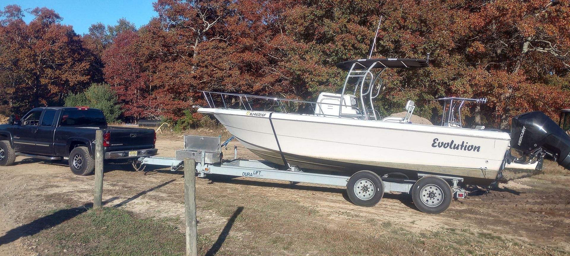 A boat is being towed on a trailer by a truck.
