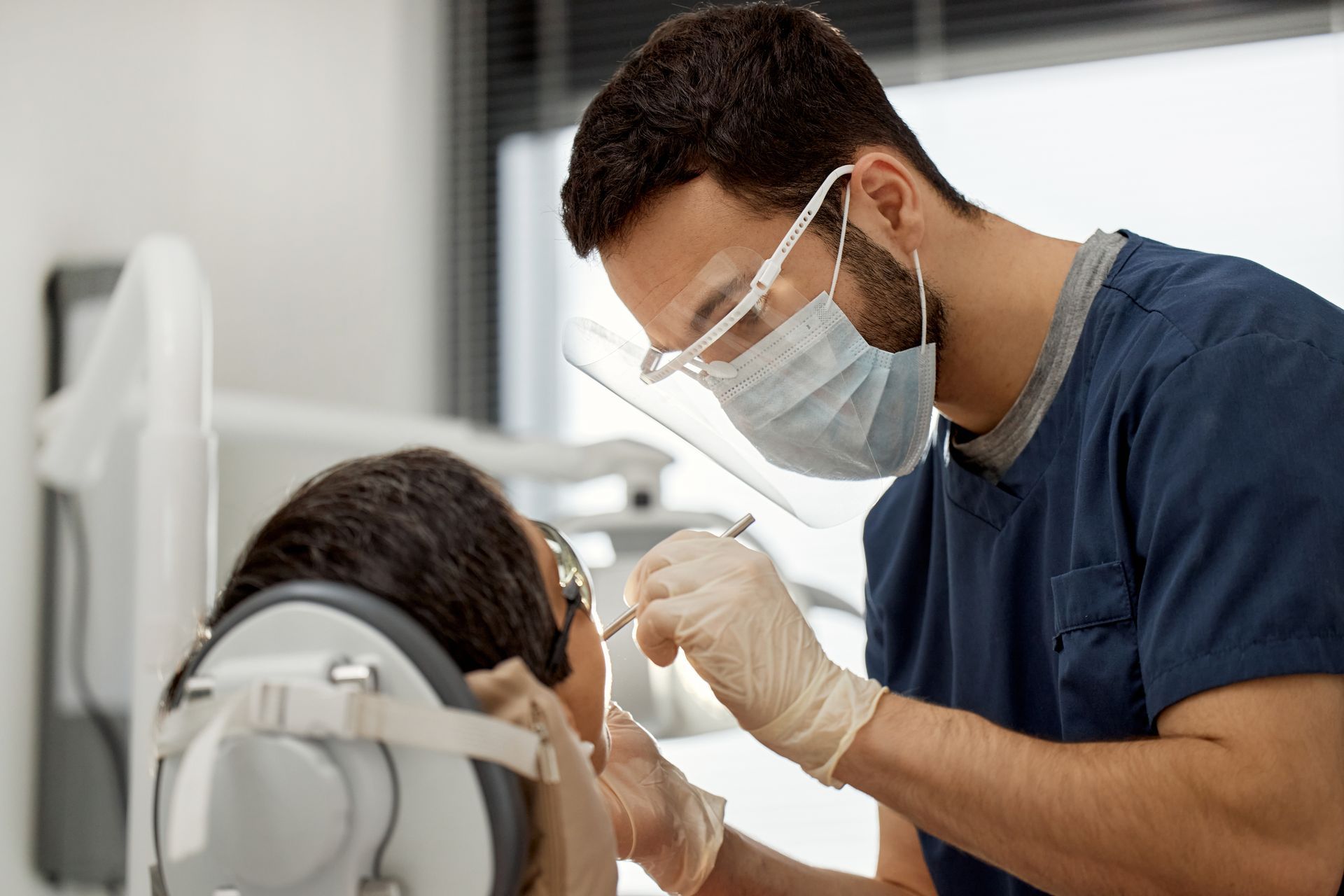 A dentist is working on a patient. A dentist is working on a patient.