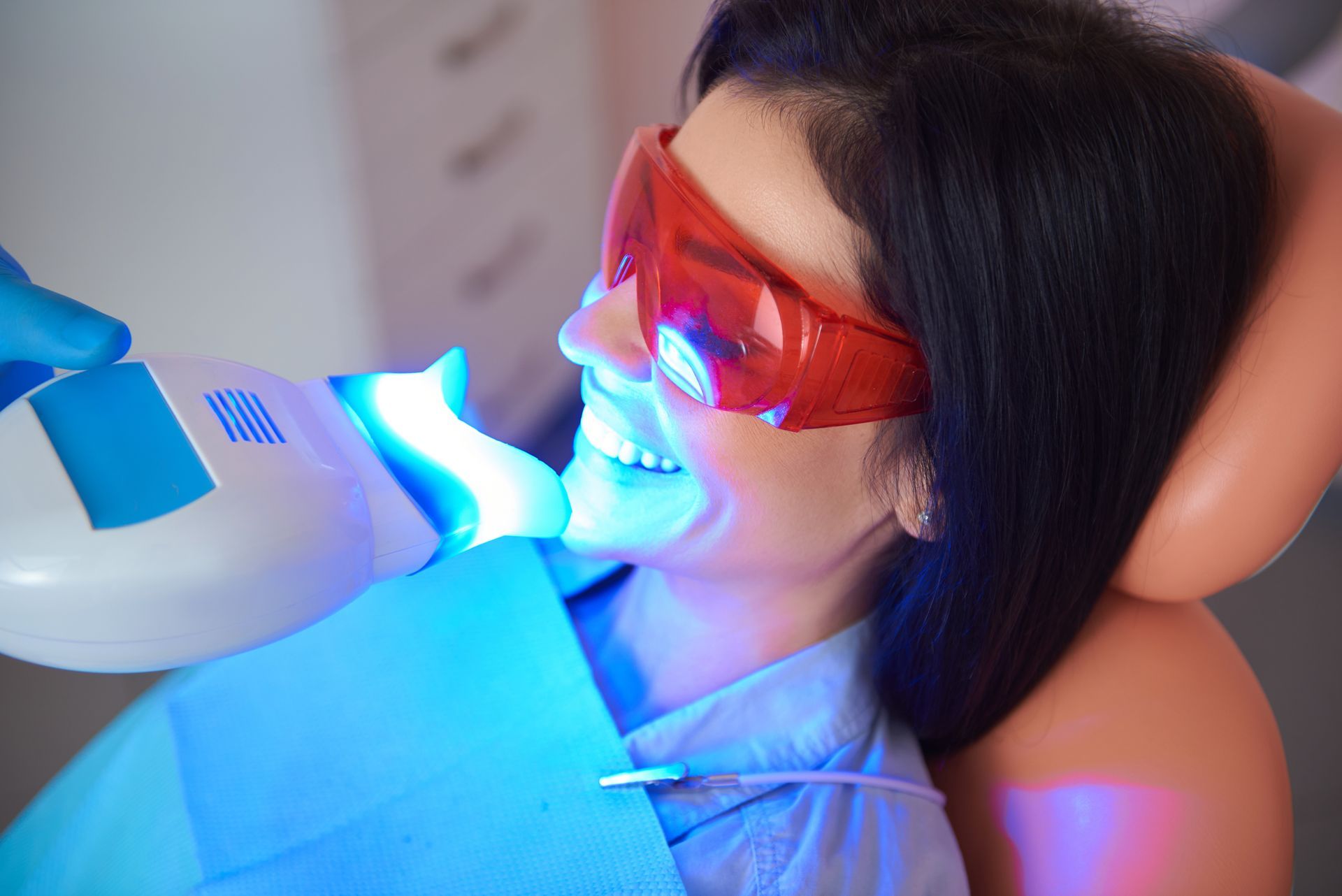 A woman is undergoing a teeth whitening procedure. A woman is undergoing a teeth whitening procedure.