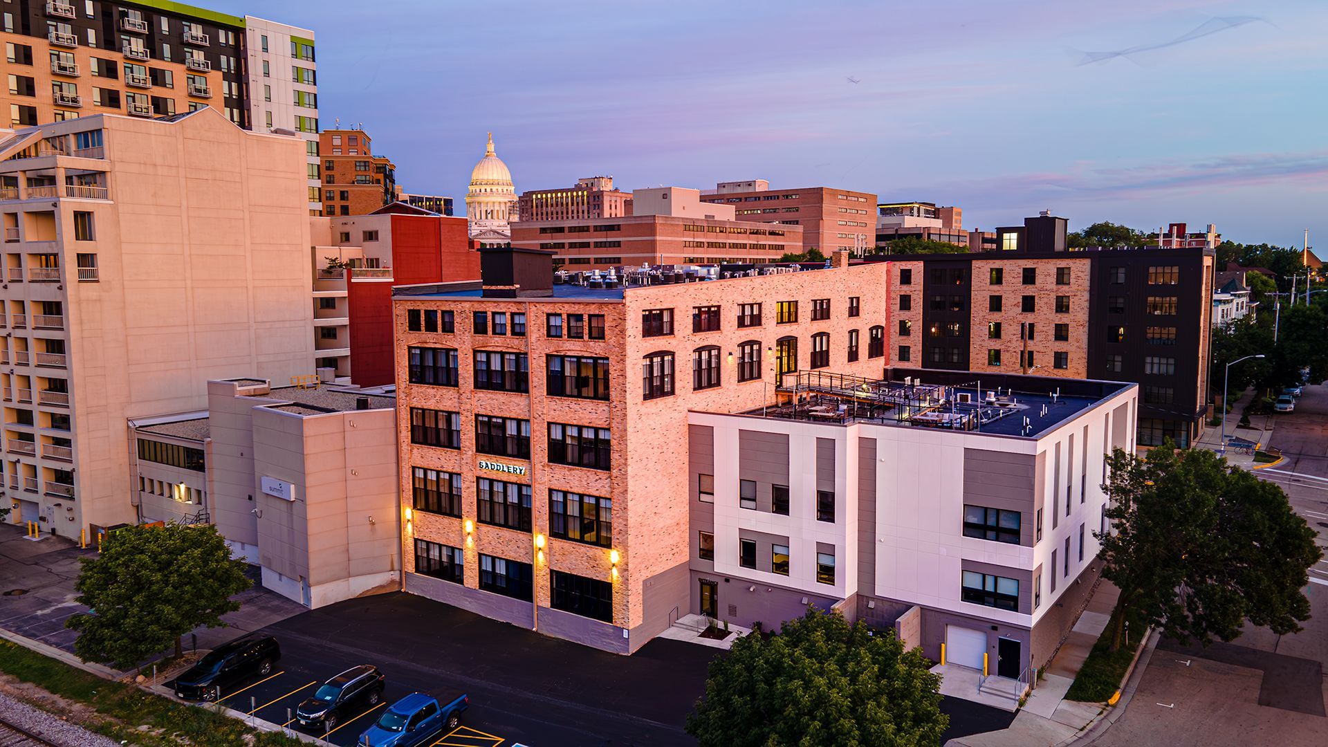 Photo of outside of The Saddlery Madison with Downtown Madision WI in background