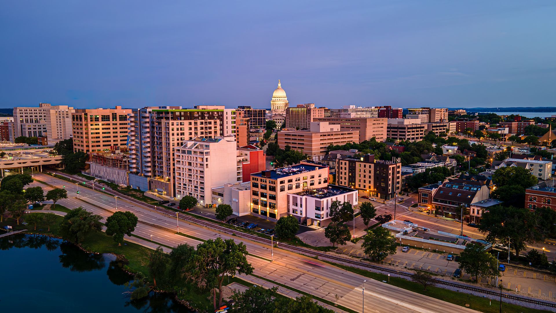 Photo of outside of The Saddlery Madison with Downtown Madision WI in background