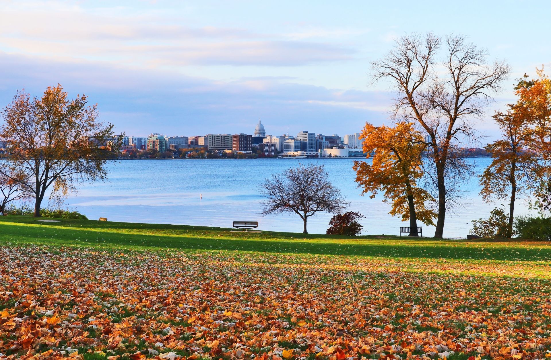 Autumn view of Madison, Wisconsin, skyline and Capitol across Lake Mendota, framed by colorful fall 