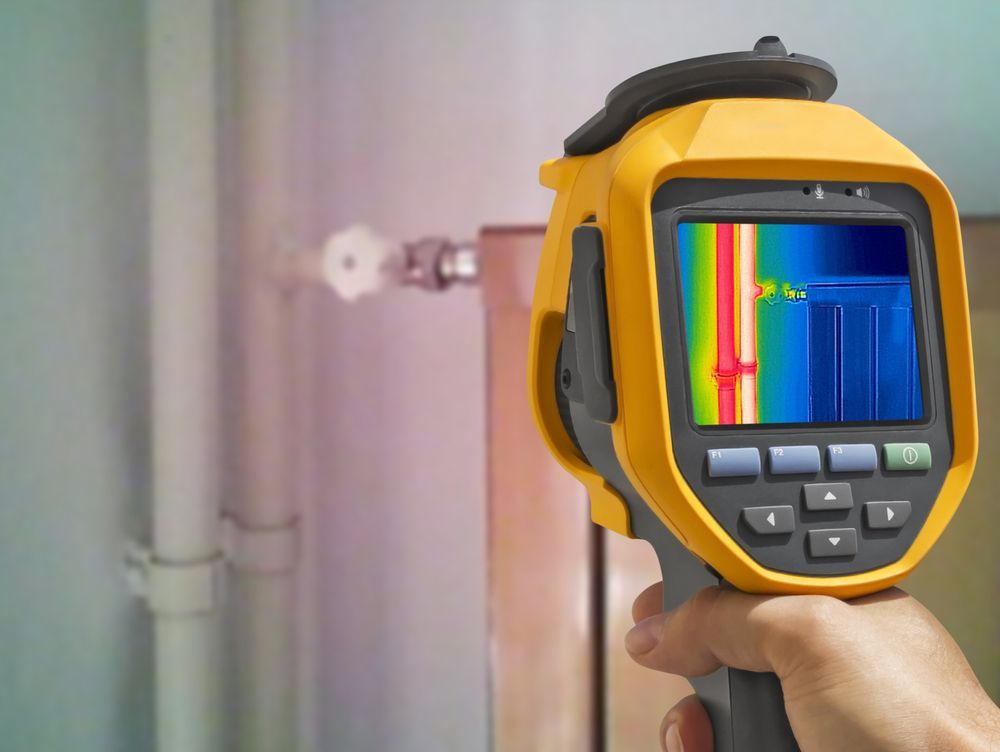 Person Holds a Yellow Thermal Imaging Camera