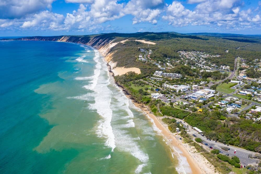 An Aerial View Of A Beach With Waves Crashing On The Shore — Malouf Plumbing In Rainbow Beach, QLD