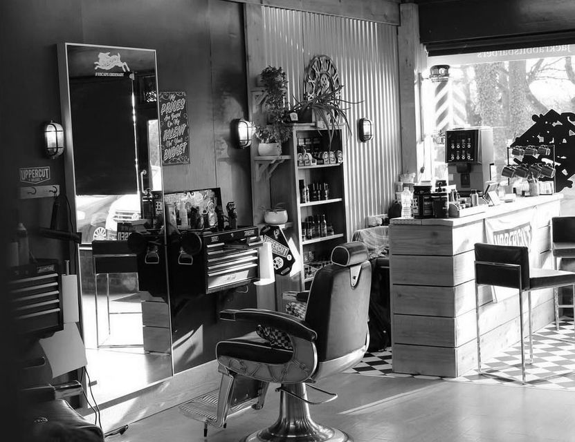 A black and white photo of a barber shop
