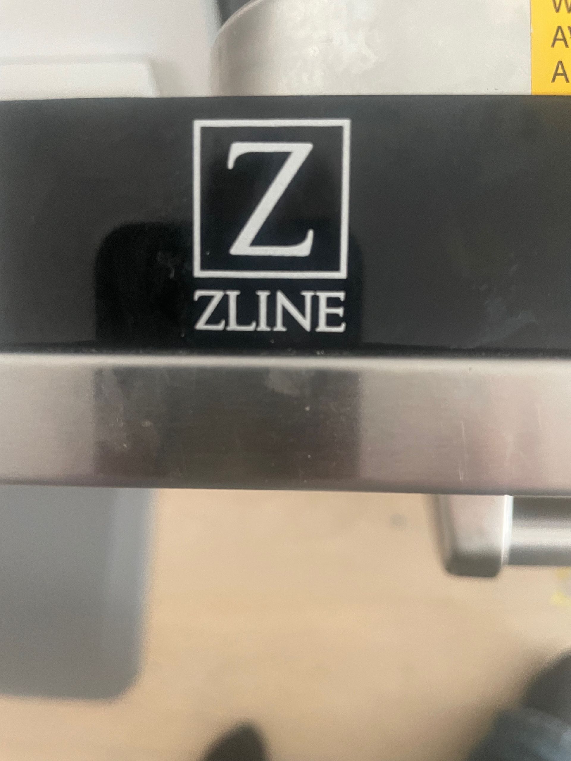 Black appliance with a Z-shaped logo in a square box. The brand name 