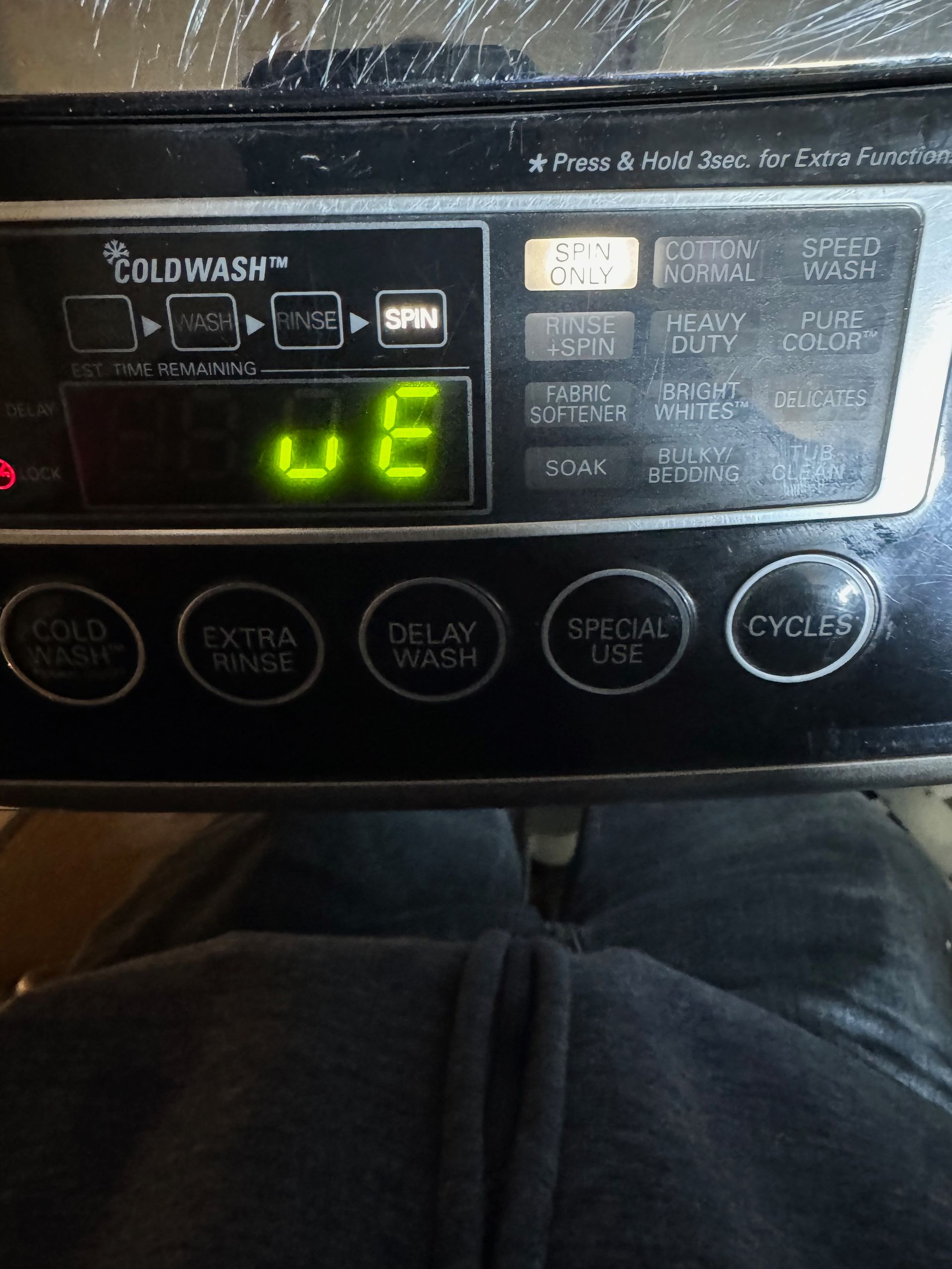 A washing machine control panel displays 