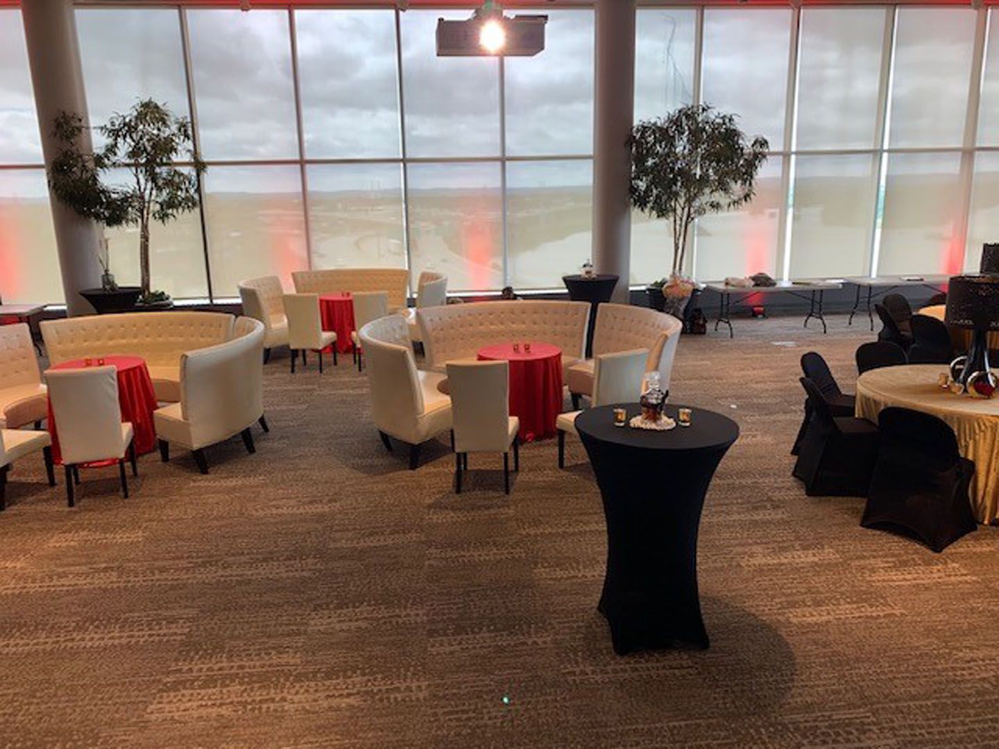 There are many tables and chairs in the room.