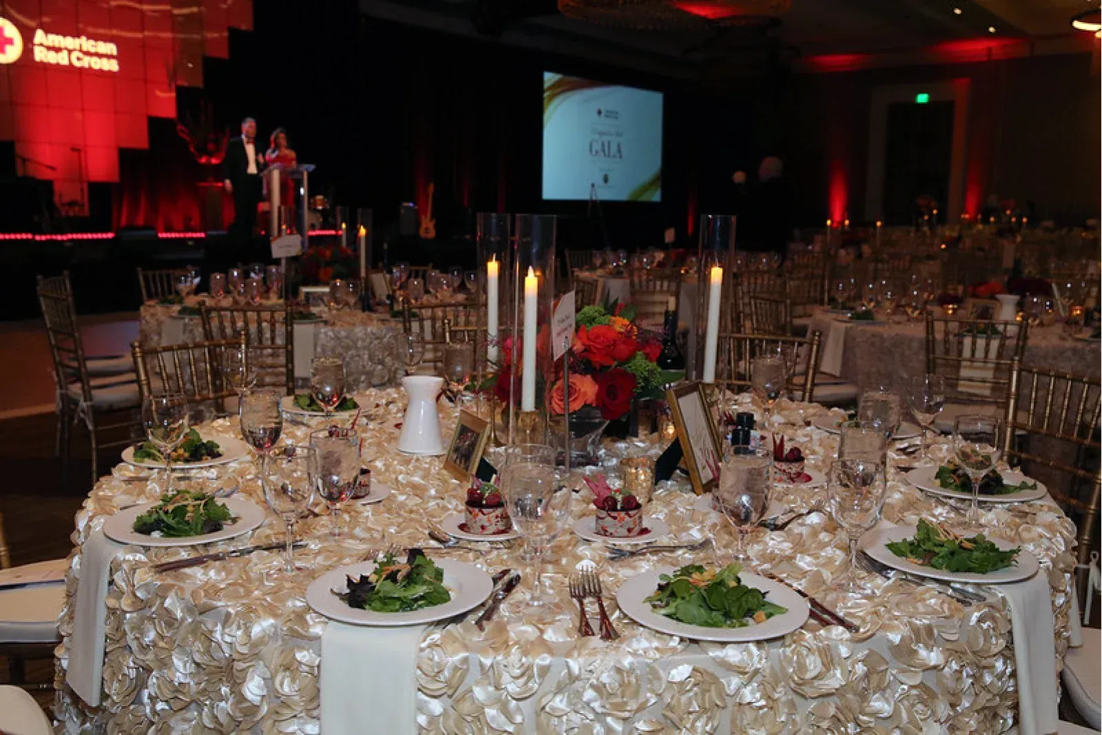 A large room with tables and chairs set up for a banquet