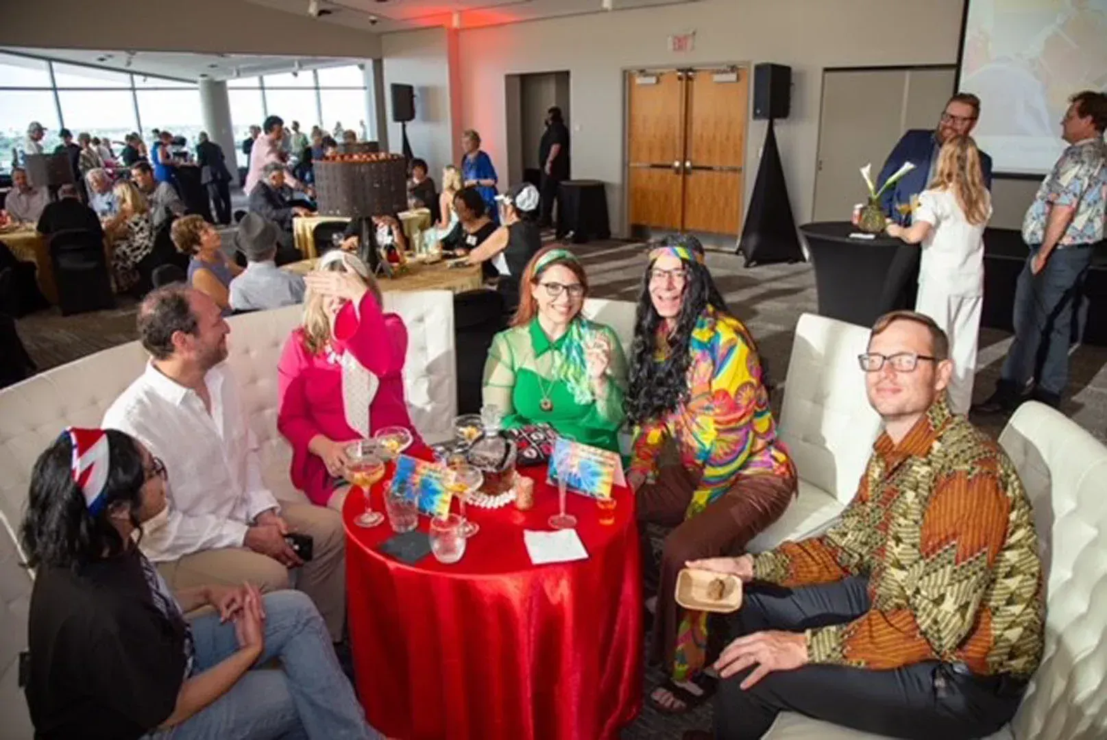 A group of people are sitting around a table in a room.