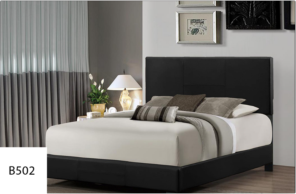 A bed with a black headboard is in a bedroom.