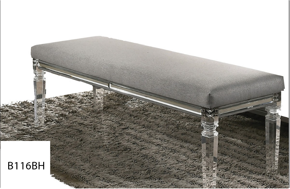 A bench with clear legs is sitting on top of a rug.