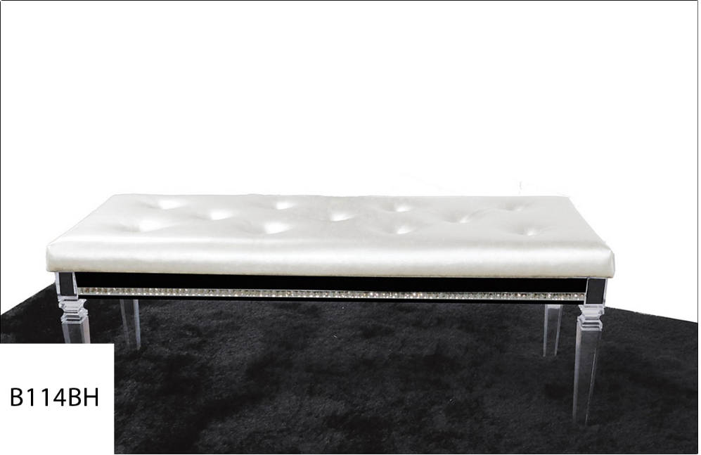 A white bench with clear legs sits on a black rug