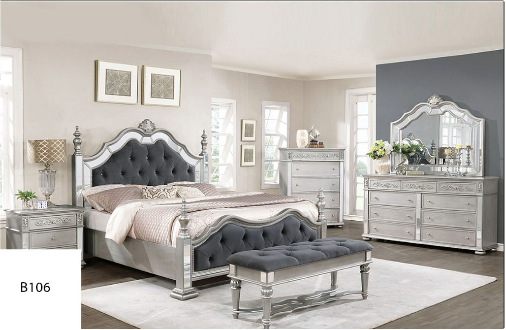 A bedroom with a bed , dresser , nightstand , mirror and bench.