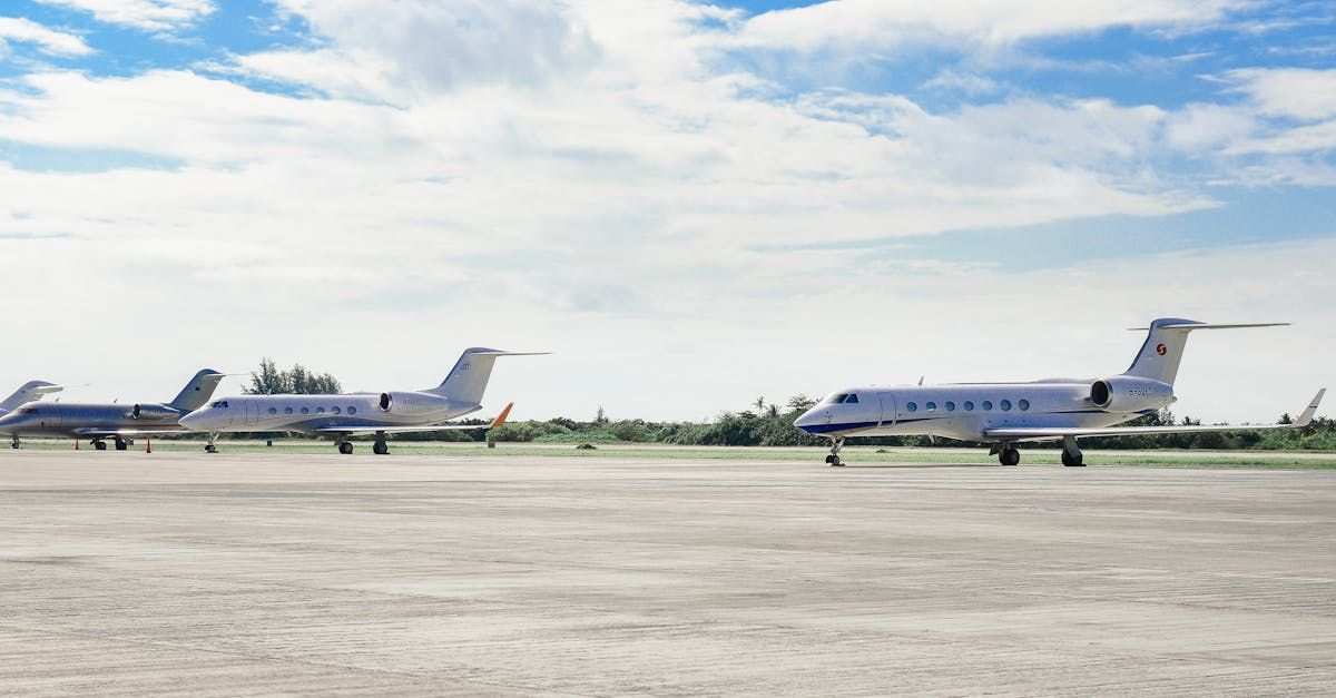 Two private jets are parked on a runway.