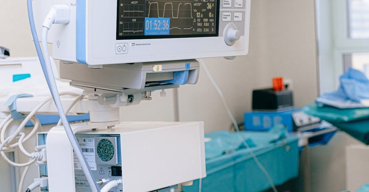 A monitor is sitting on top of a table in an operating room.