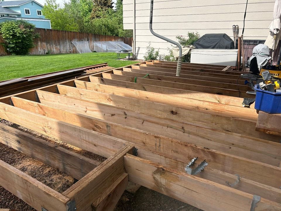 Wooden deck frame under construction outdoors.