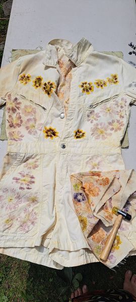 White outfit with floral imprints is laid out on a table.