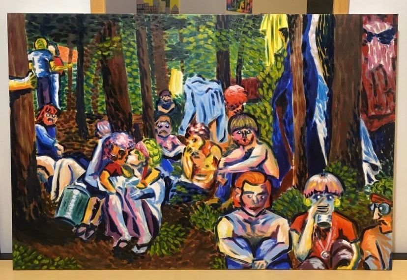 People gather in a sunlit forest clearing with hanging clothes.