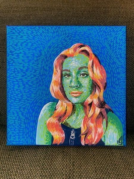 Green-skinned woman with orange hair against a blue dotted background. Wearing a black top, portrait style.