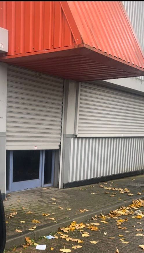 A building with a red awning on top of it.