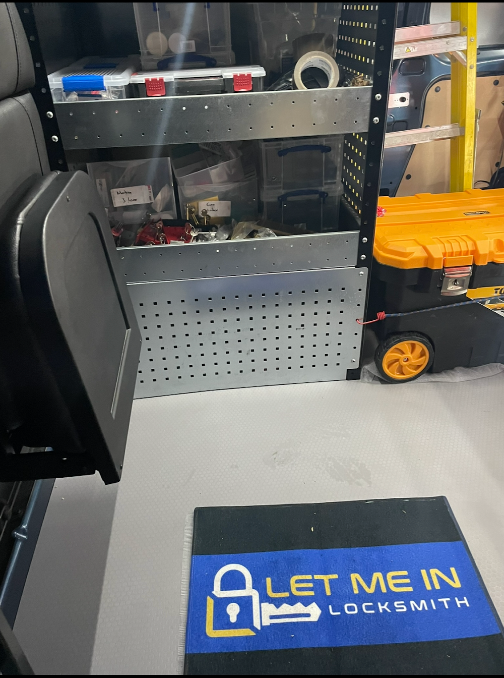 A blue mat that says let me in locksmith on it