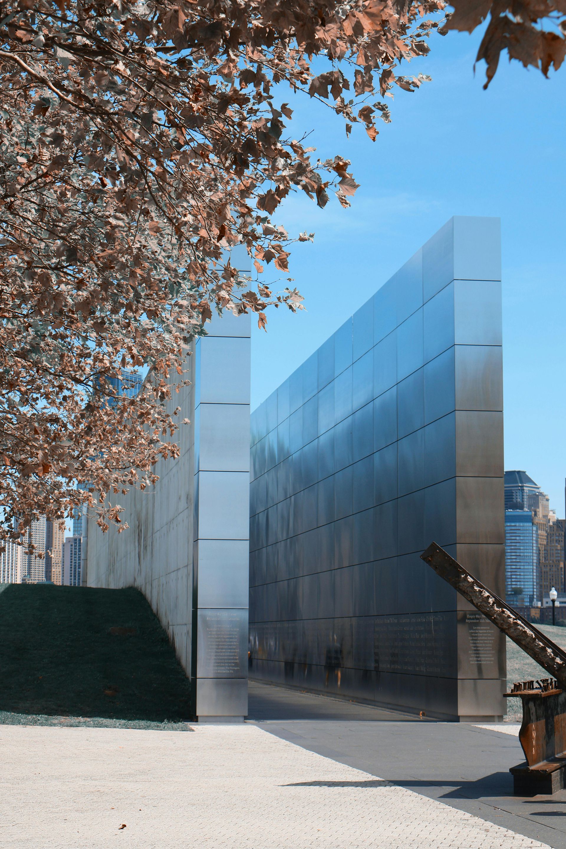 A large metal wall with a statue in front of it