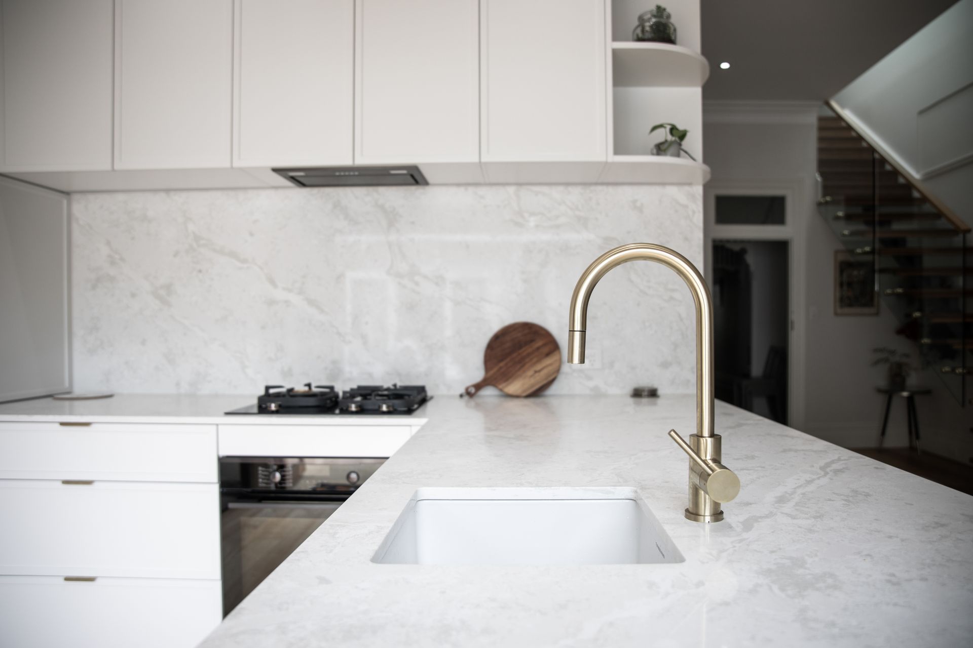 A modern kitchen with a stone benchtop.