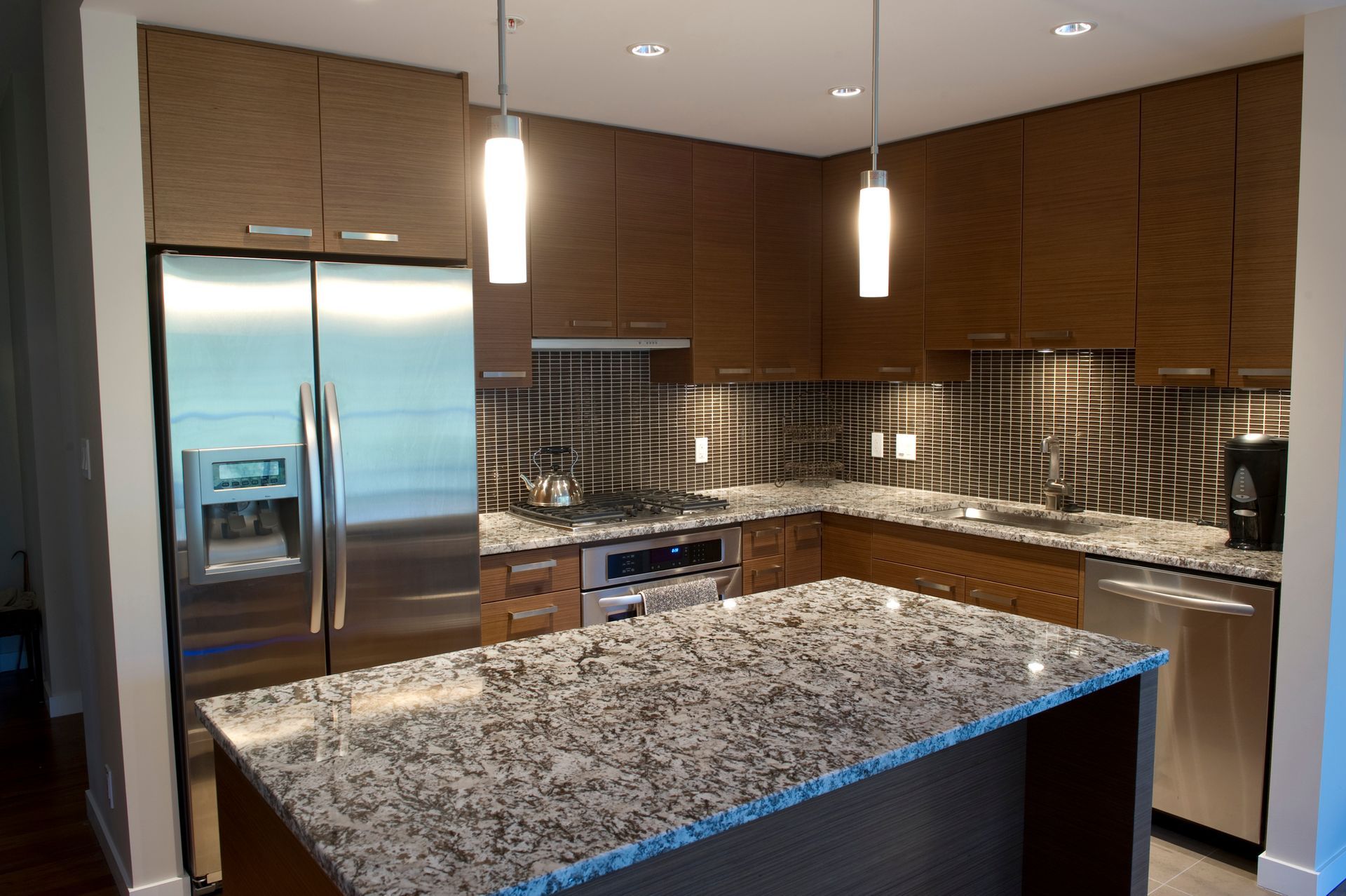 Modern kitchen with granite tops and stainless appliances.