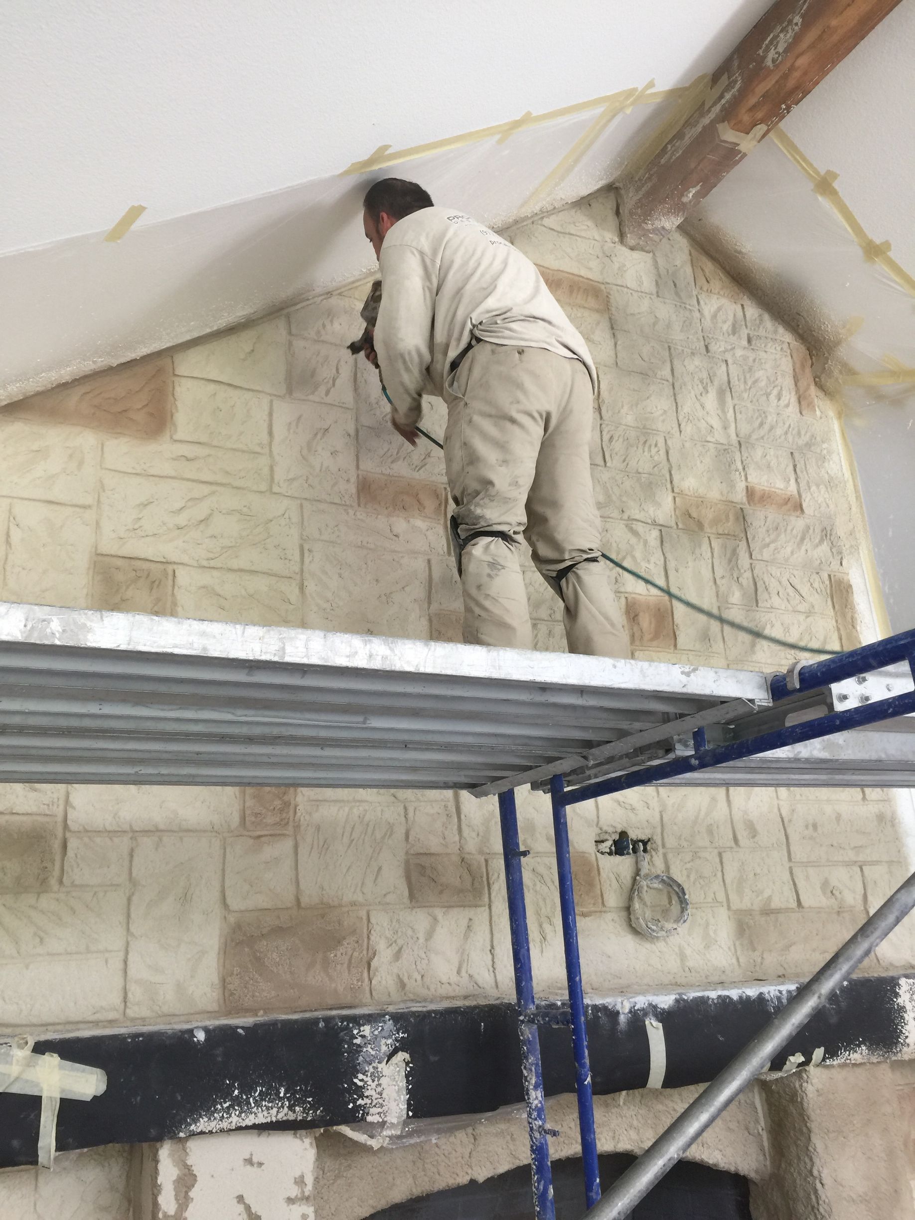 Night 'N' Day Construction completing a total home remodel in Dallas, TX, featuring a fireplace transformation from brick to a limestone finish