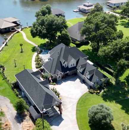 Exterior renovation on a customer's home in Whitehouse, Texas, featuring a new composition shingle roof, freshly painted siding, soffit, fascia, garage doors and new gutters.