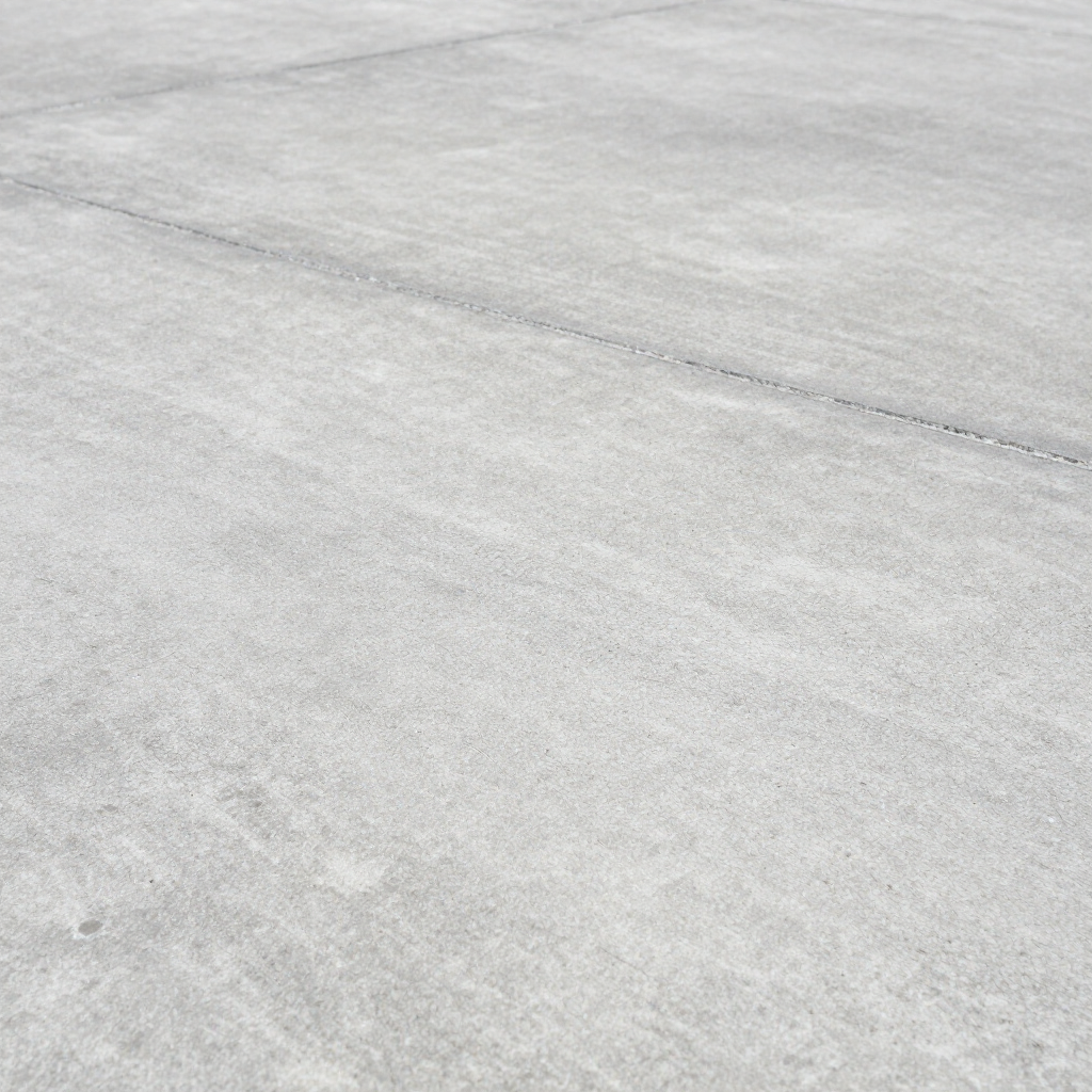 A light gray concrete surface with a faint diagonal expansion joint running across it.