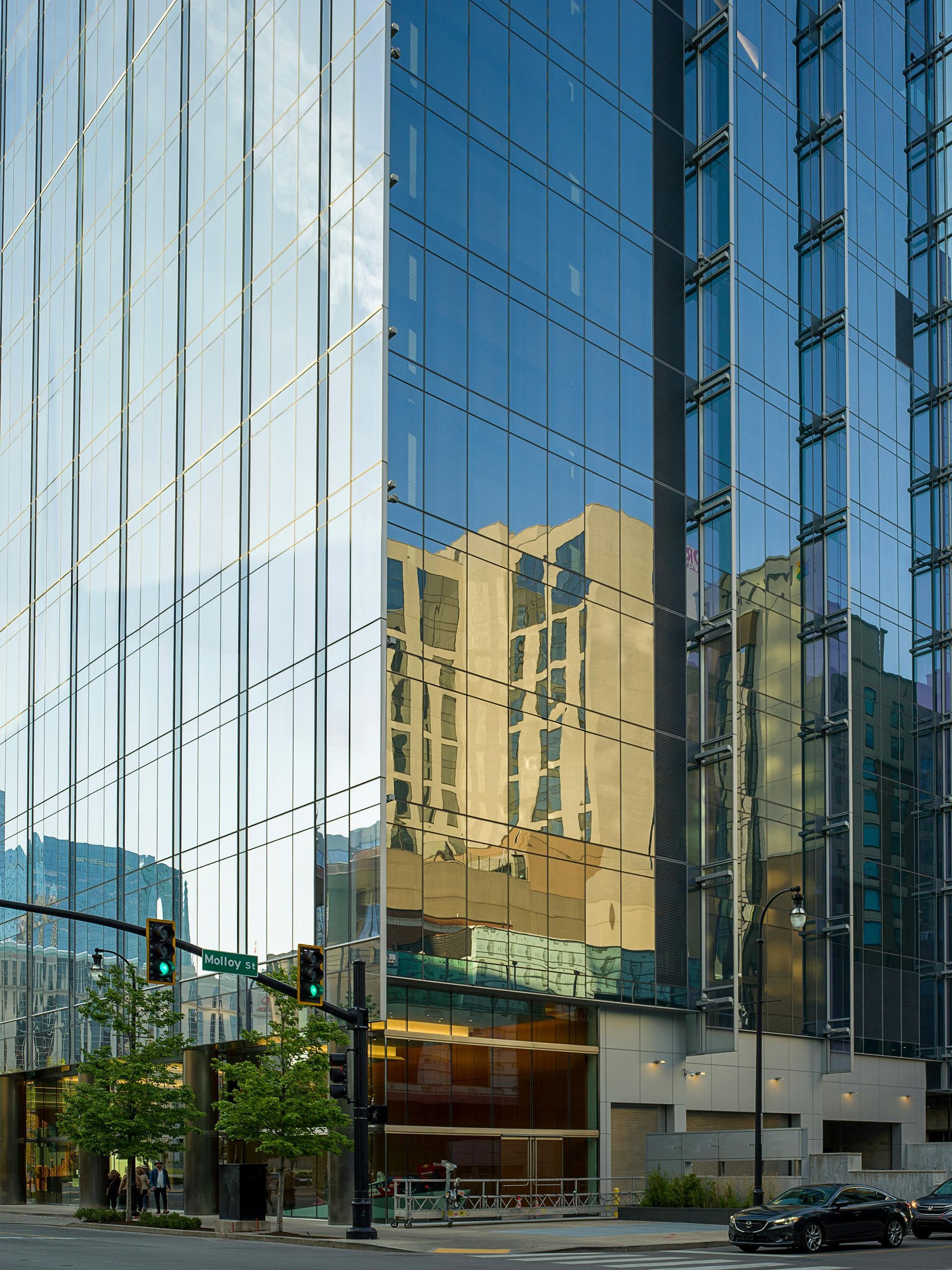 A tall building with a lot of windows and a car parked in front of it
