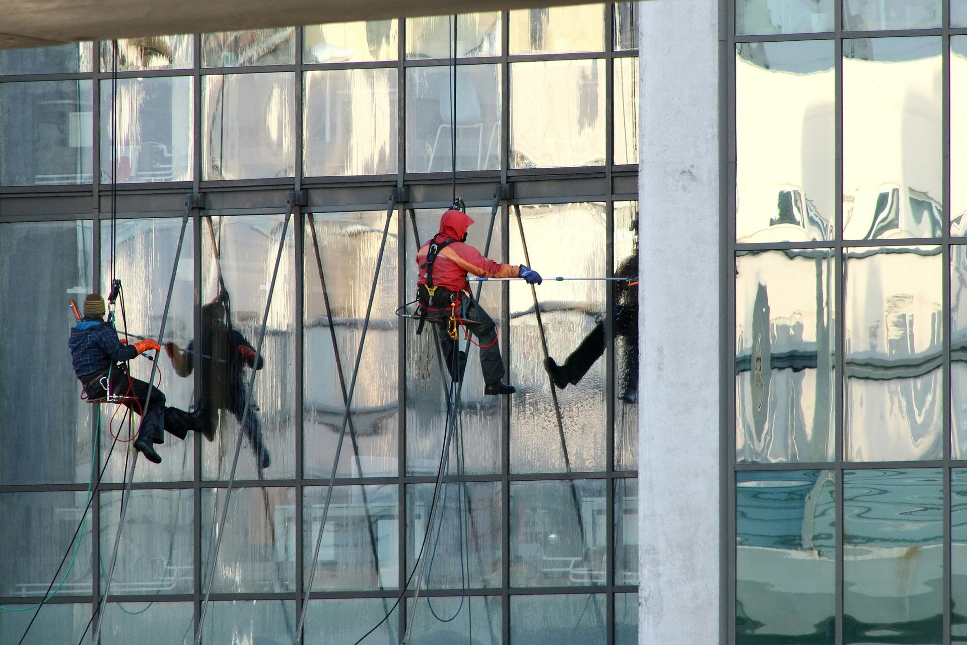 A man is cleaning a window with a squeegee.