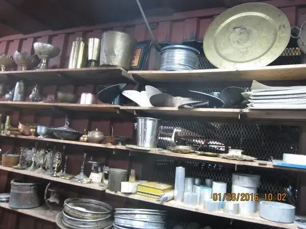 Shelves filled with a variety of items including plates.