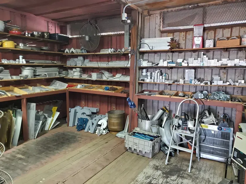 A garage filled with lots of tools and shelves.