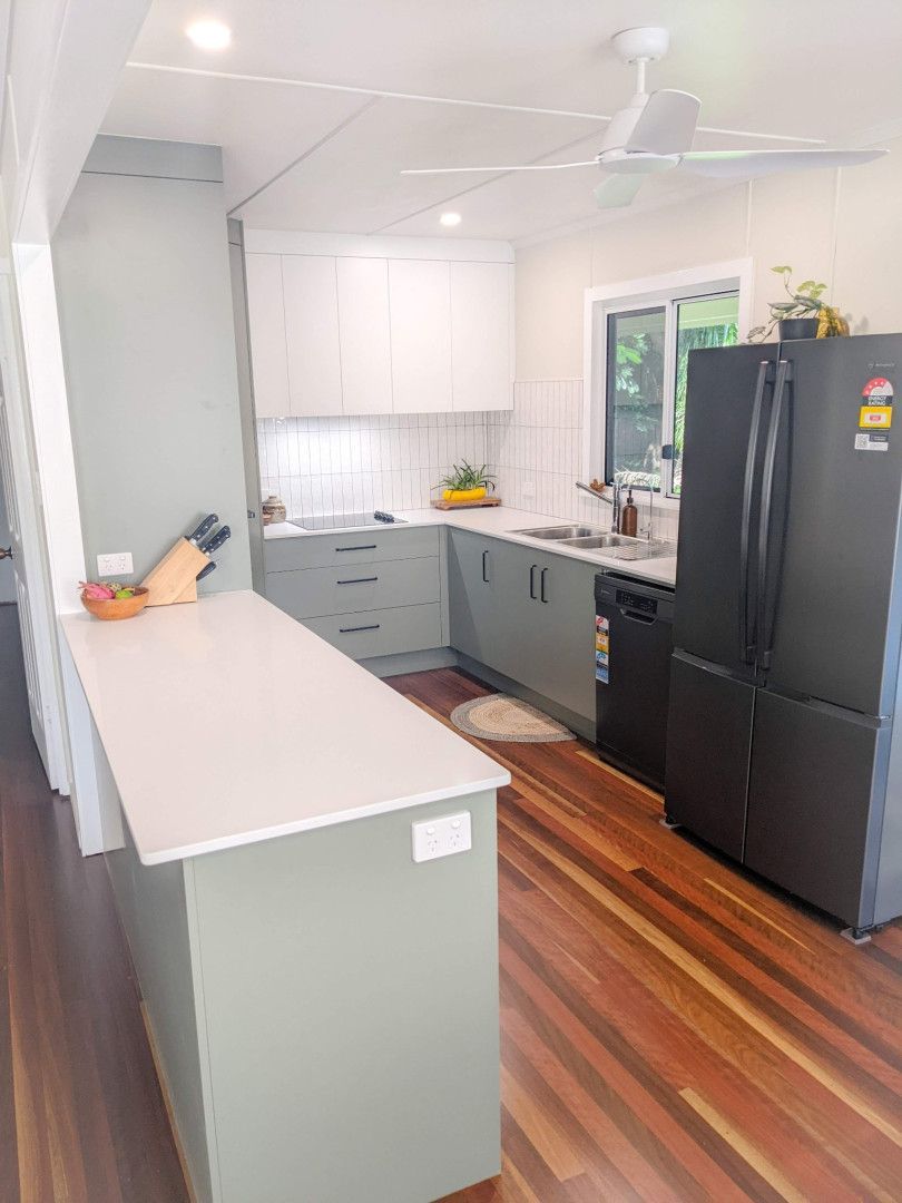 A Kitchen With a Black Refrigerator and a Wooden Floor — Olive & White Cabinetmaking in Park Avenue, QLD