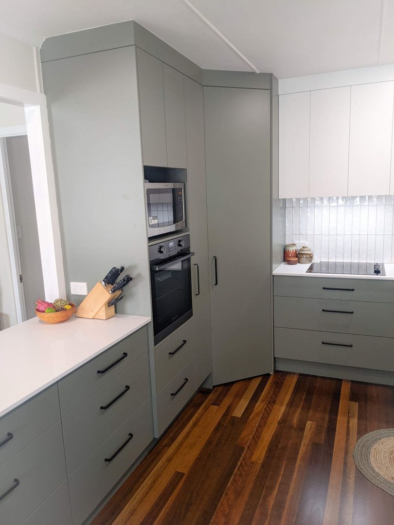 A Kitchen With Gray Cabinets and Wooden Floors — Olive & White Cabinetmaking in Park Avenue, QLD