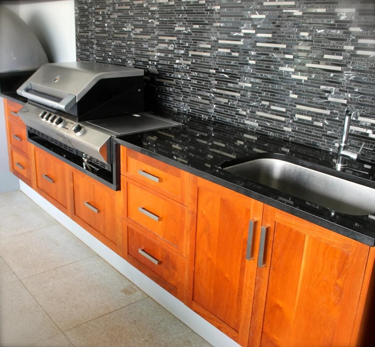 A Kitchen With Wood Cabinets and a BBQ on the Counter — Olive & White Cabinetmaking in Park Avenue, QLD