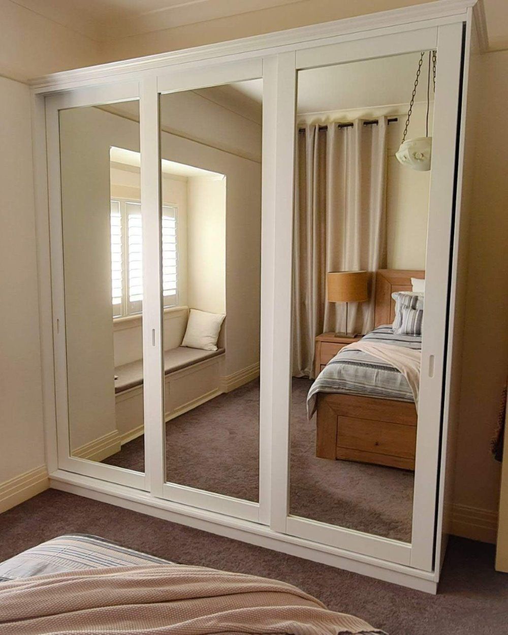 A Bedroom With a Large Mirrored Wardrobe and a Bed — Olive & White Cabinetmaking in Park Avenue, QLD