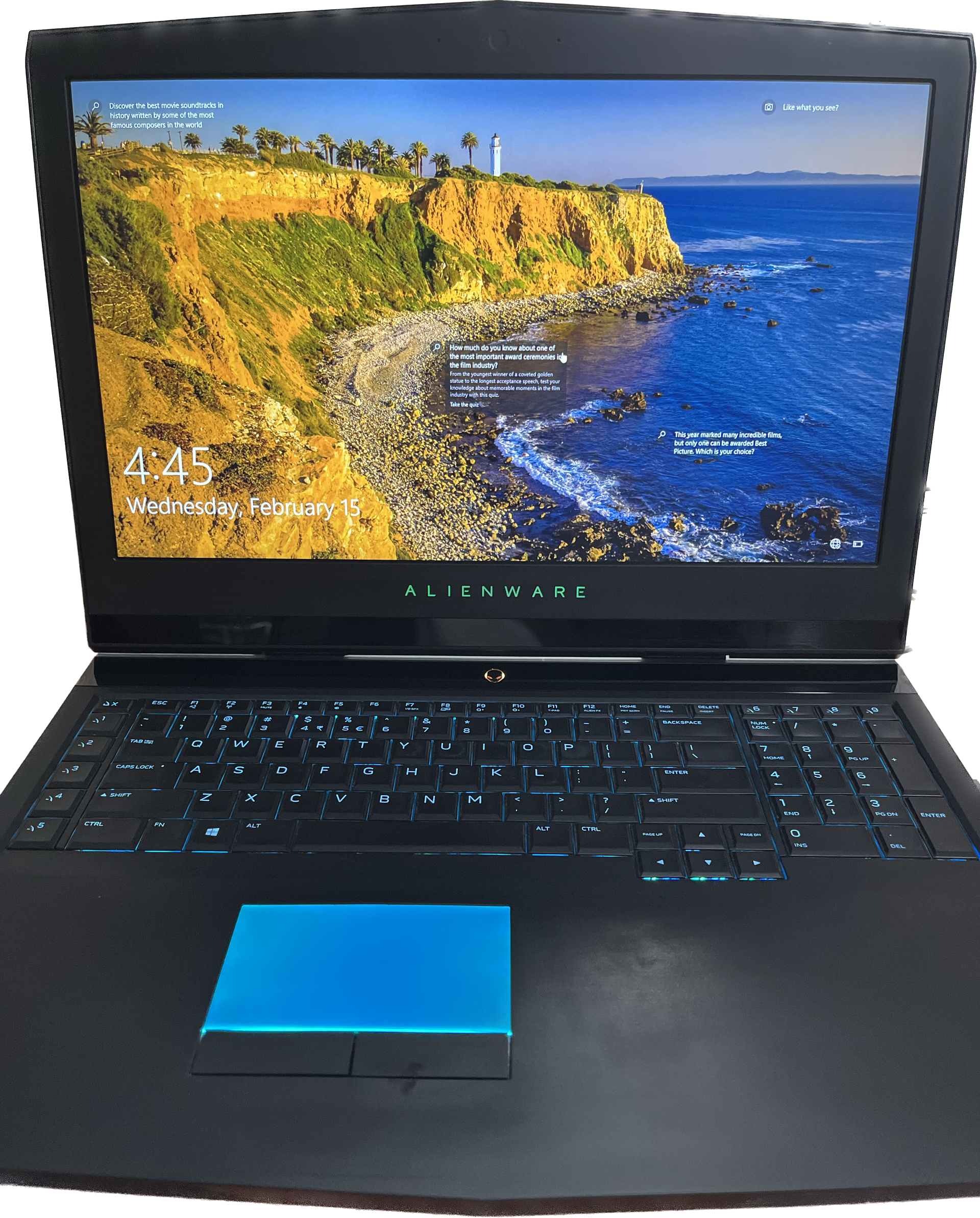 alienware gaming laptop with screen open. pc is completed bootup with screen locked and some text seen on screen