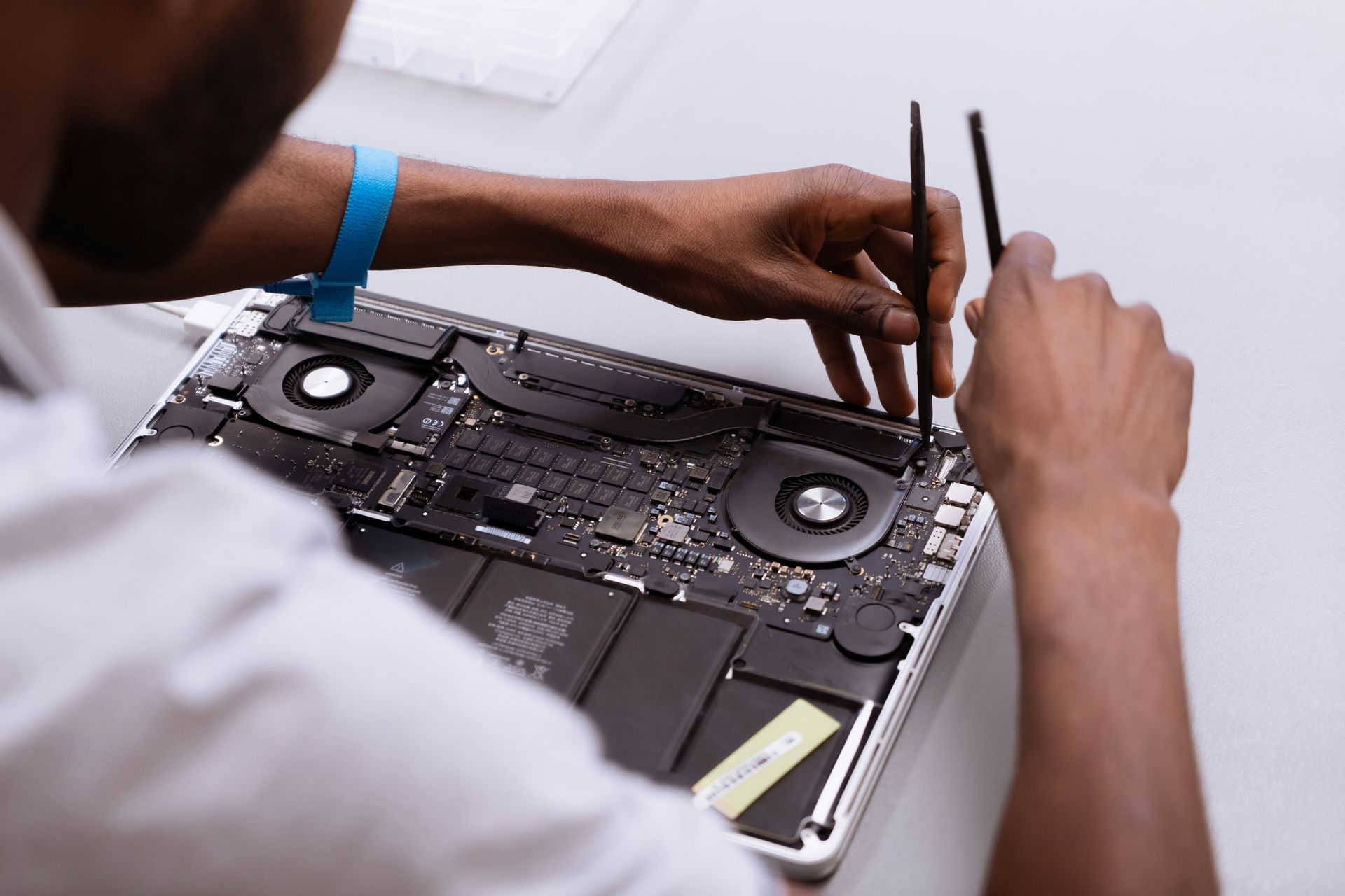 Close-up of laptop internal hardware repair by Atikoom in Baton Rouge, bottom panel removed
