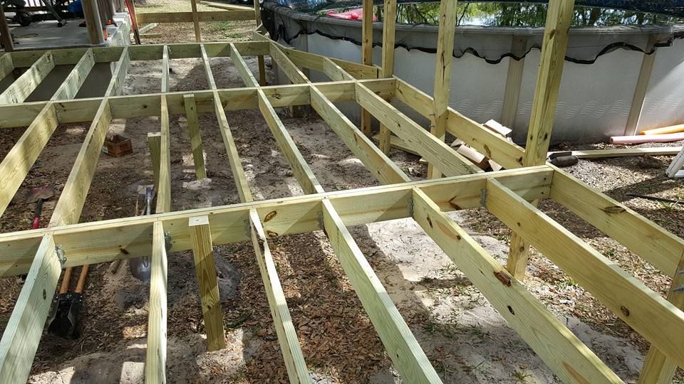 Wooden deck frame under construction outdoors. Wooden deck frame under construction outdoors.