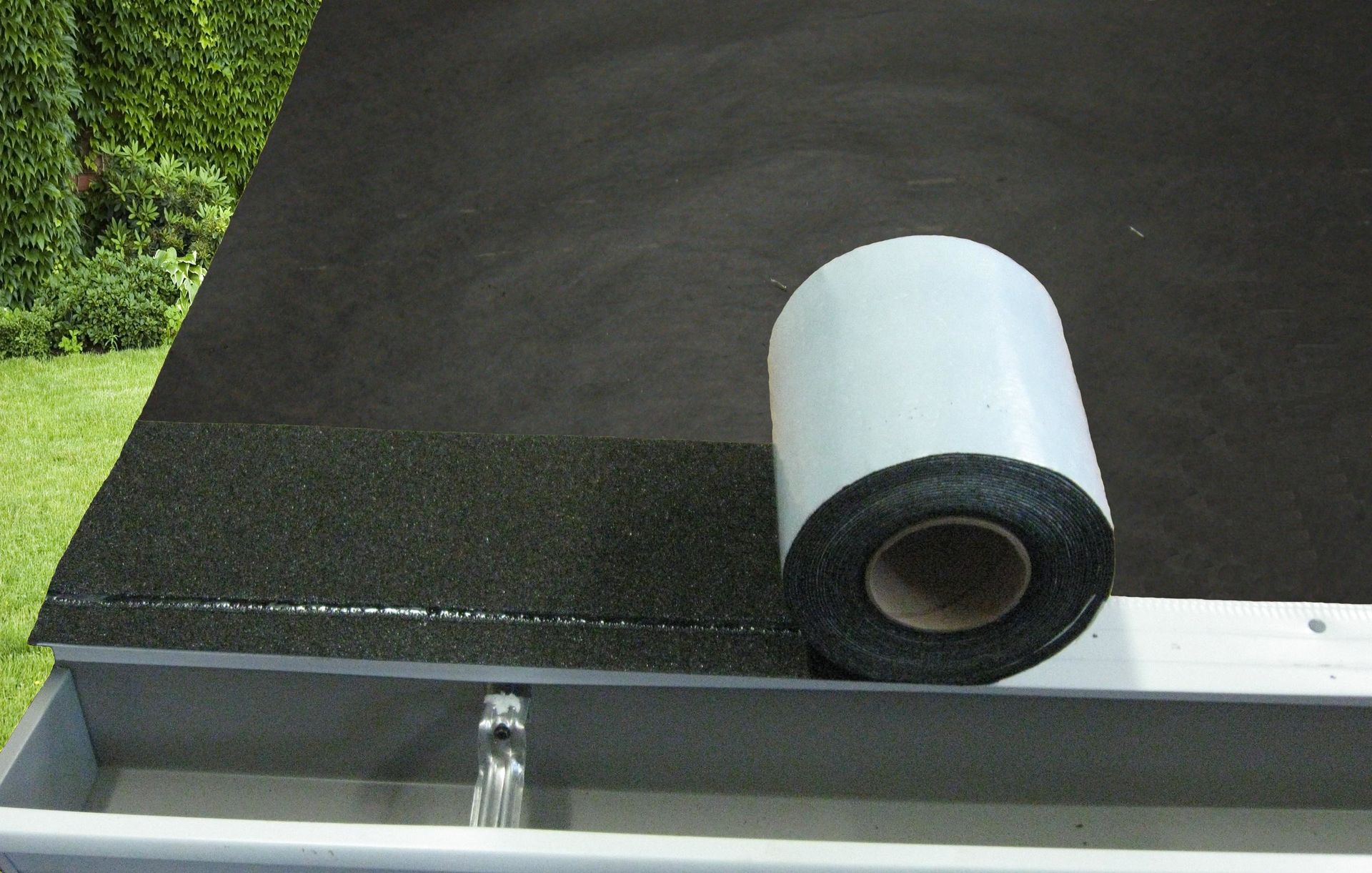 A roll of tape is sitting on top of a roof.