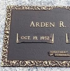 Gravestone plaque with the name Arden R. and date Oct. 19, 1952, with “Together Forever” plaque.